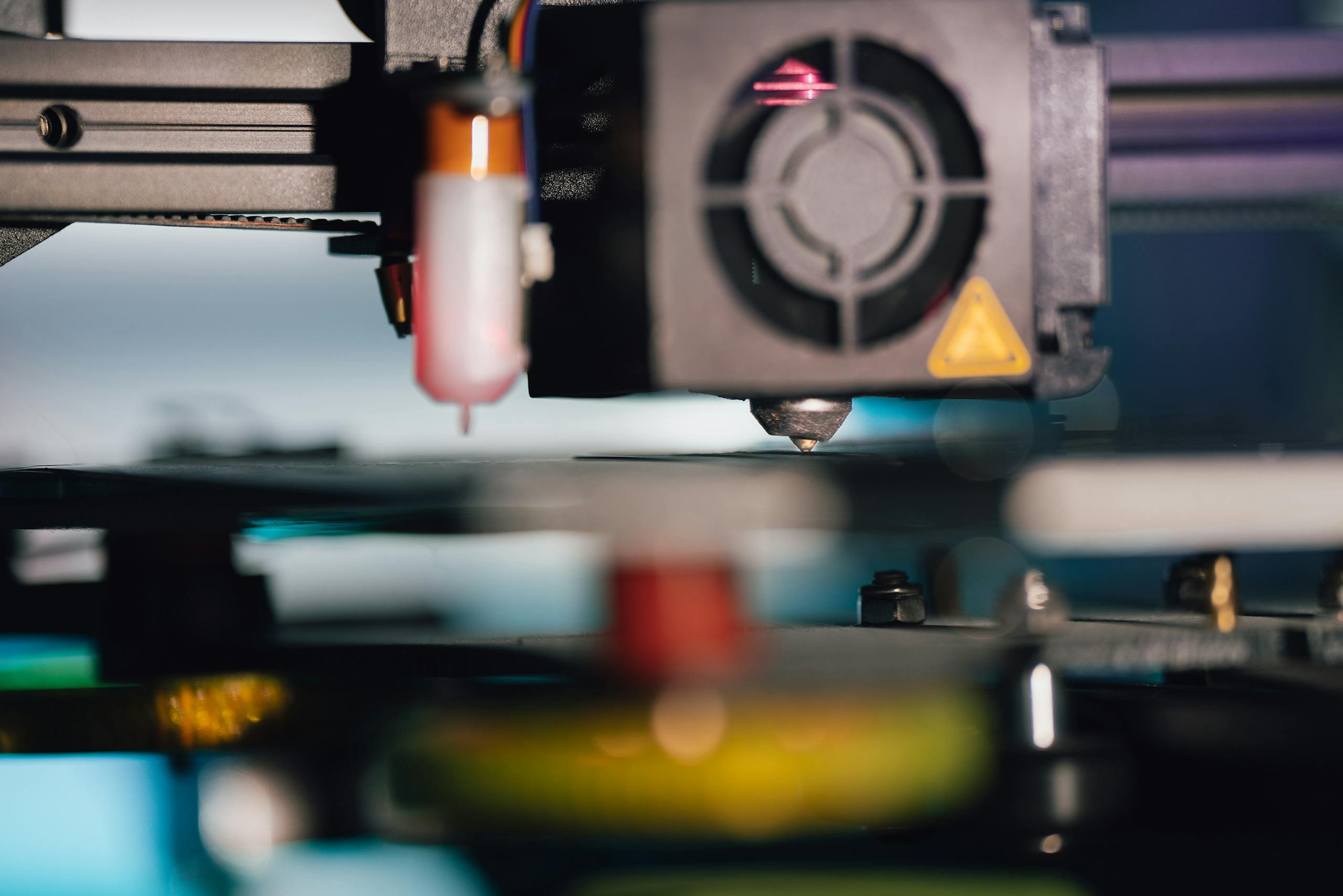 Detailed view of a 3D printer extruder, showcasing modern technology and precision.