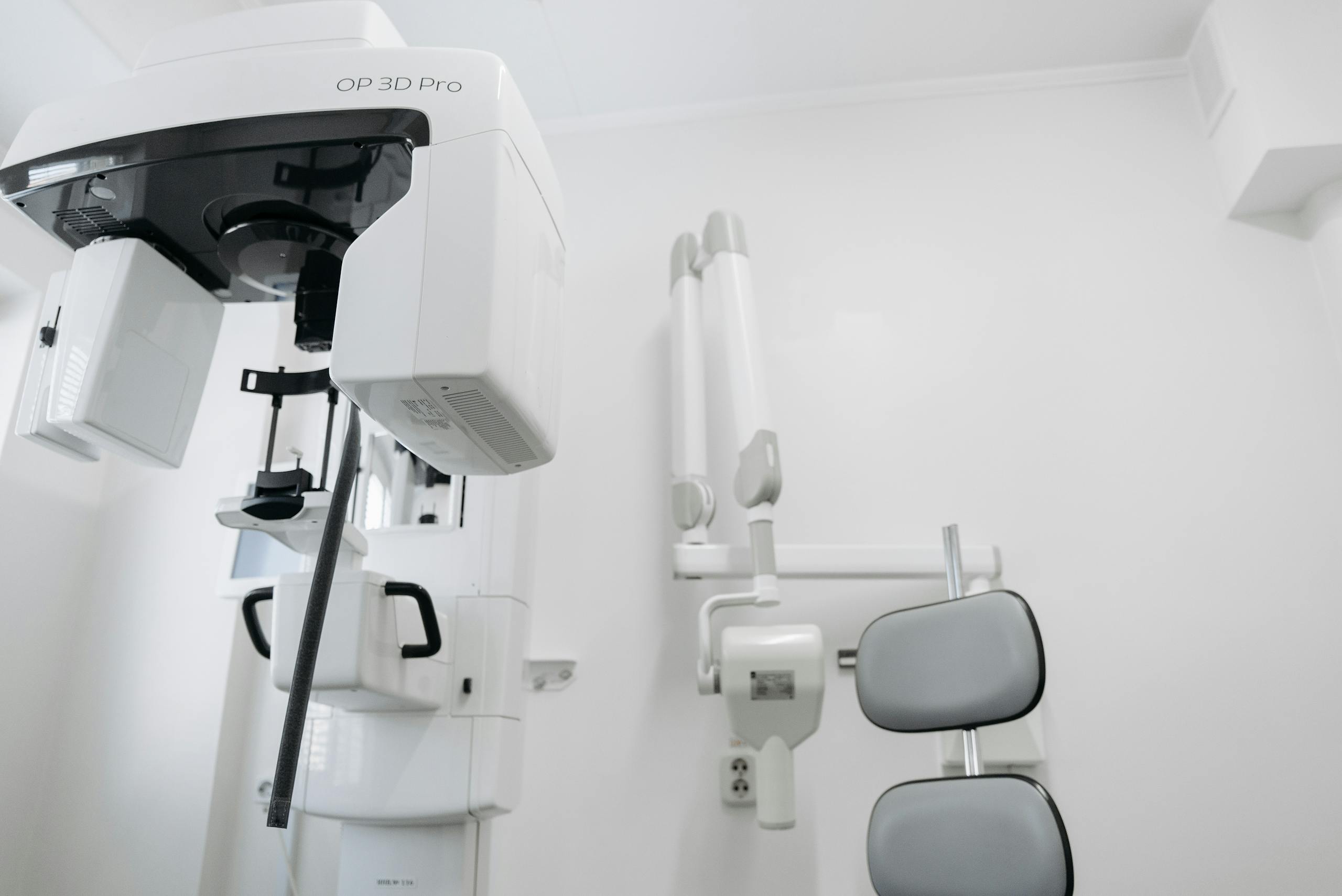 High-tech dental imaging equipment in a clean, white clinic setting.